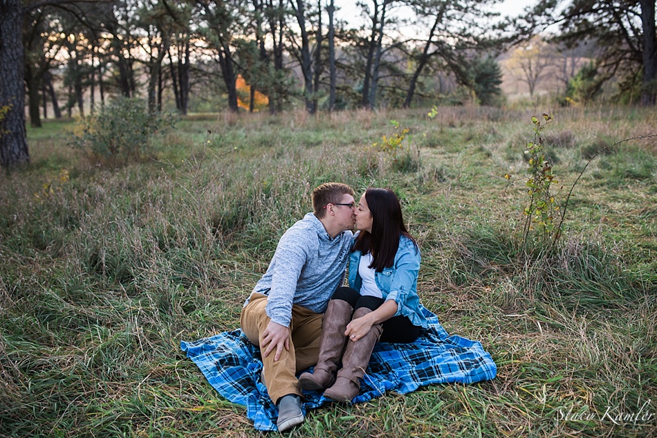 Sitting on blue plaid blanket for engagement photos