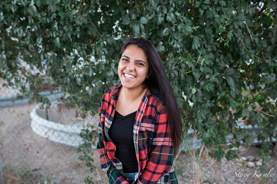 Senior girl wearing red plaid button down