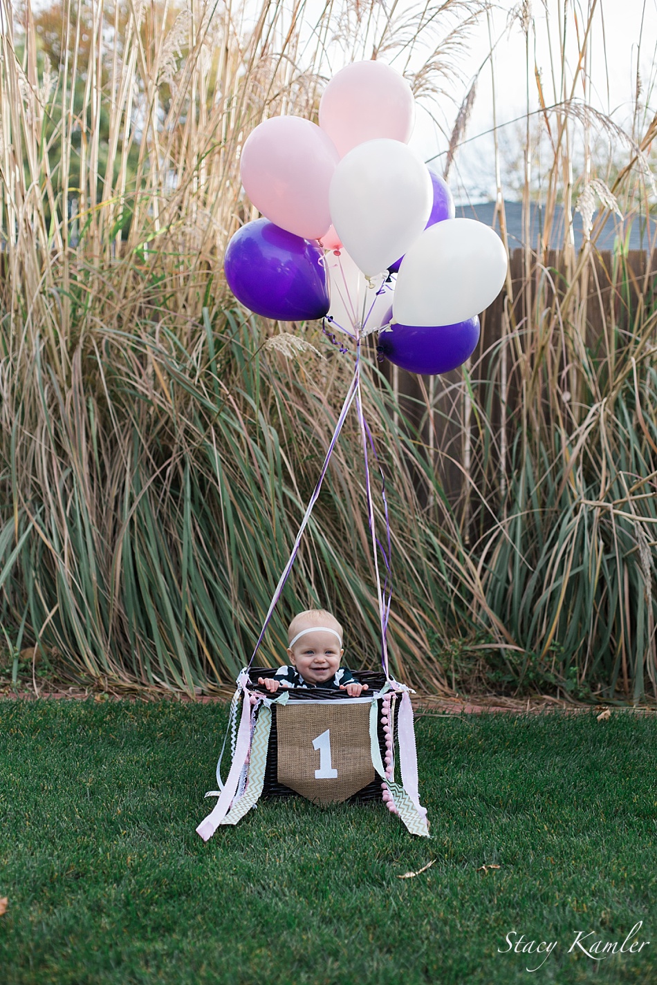 One year old with Purple Balloons