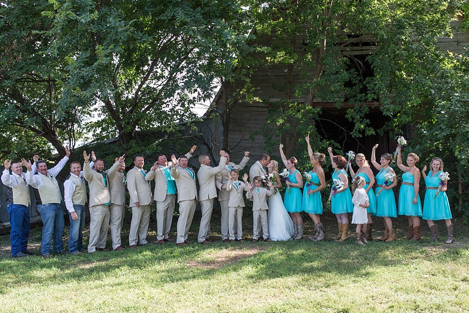 Entire wedding party photos in front of barn