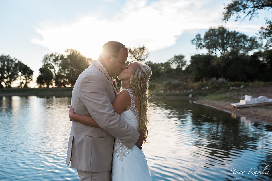 Bride and Groom portraits in front of lake at sunset