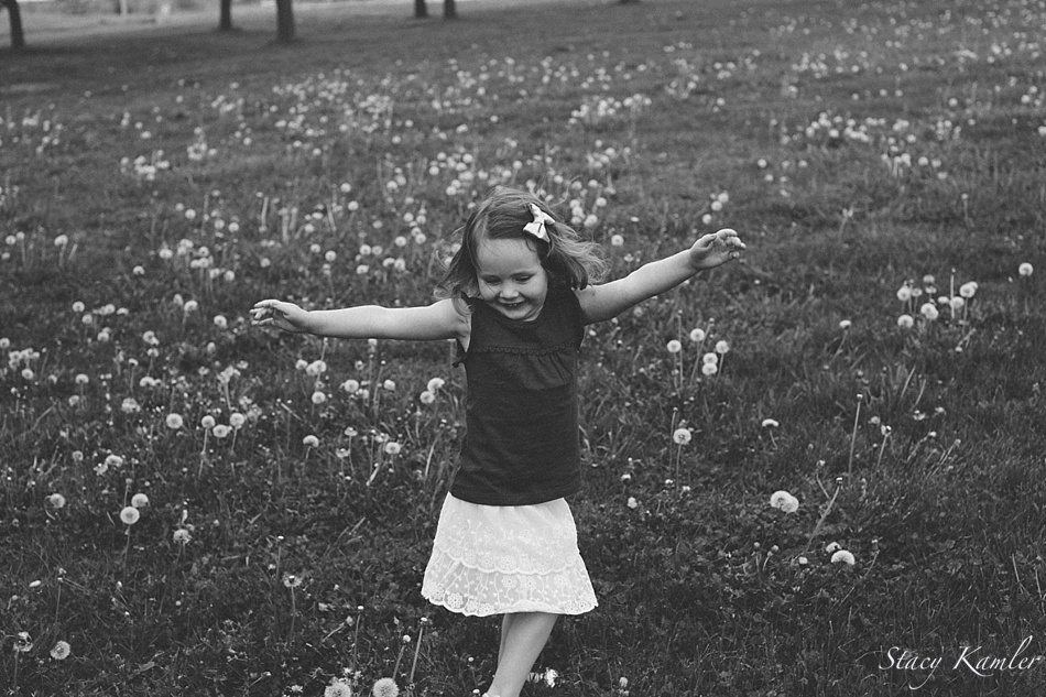 3 year old running in a field of dandelions