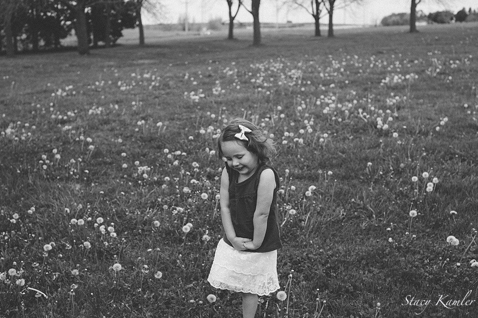 3 year old running in a field of dandelions
