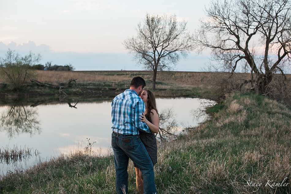 Couple by family pond for engagement session