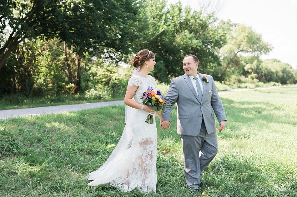 Bride and Groom Walking in Grass