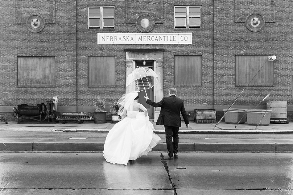 Bride and Groom walking in the rain