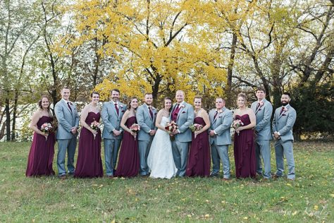 Wedding party with grey tuxes and maroon dresses