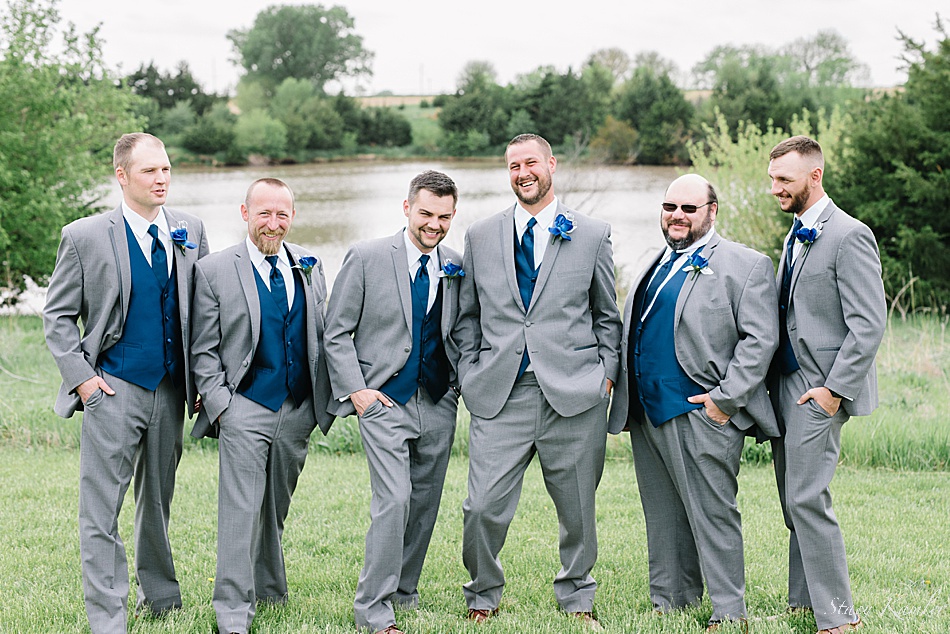 Groomsmen in grey tuxes and blue vest