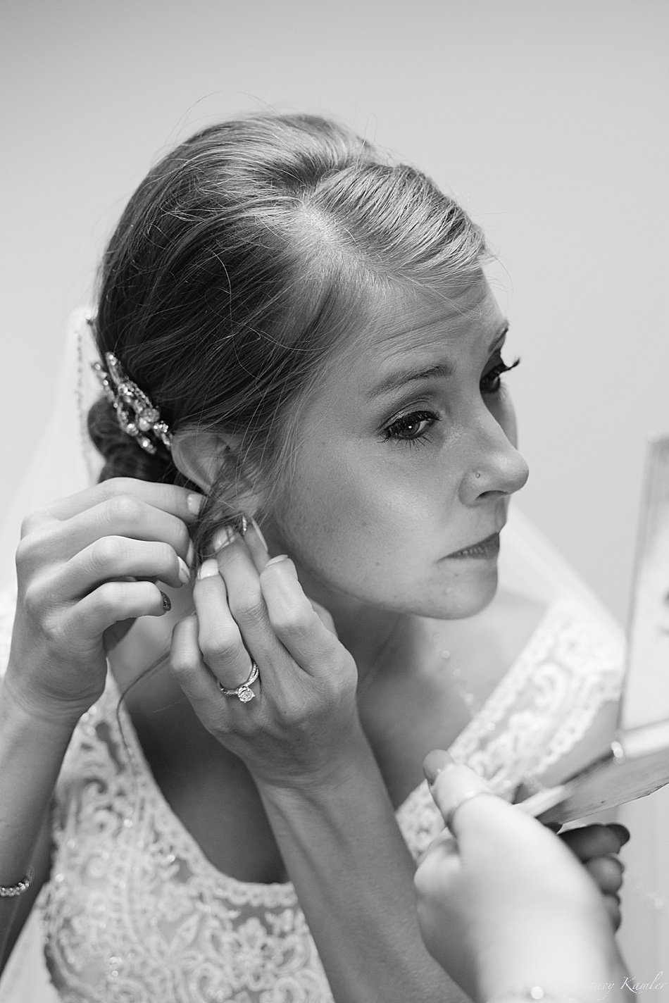 Bride putting in earrings