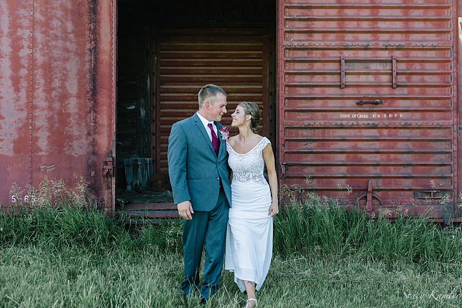 Bride and Groom Portraits in from of a red train car