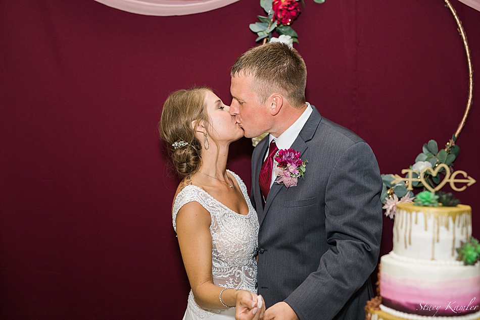 Bride and Groom kissing after the cake cutting