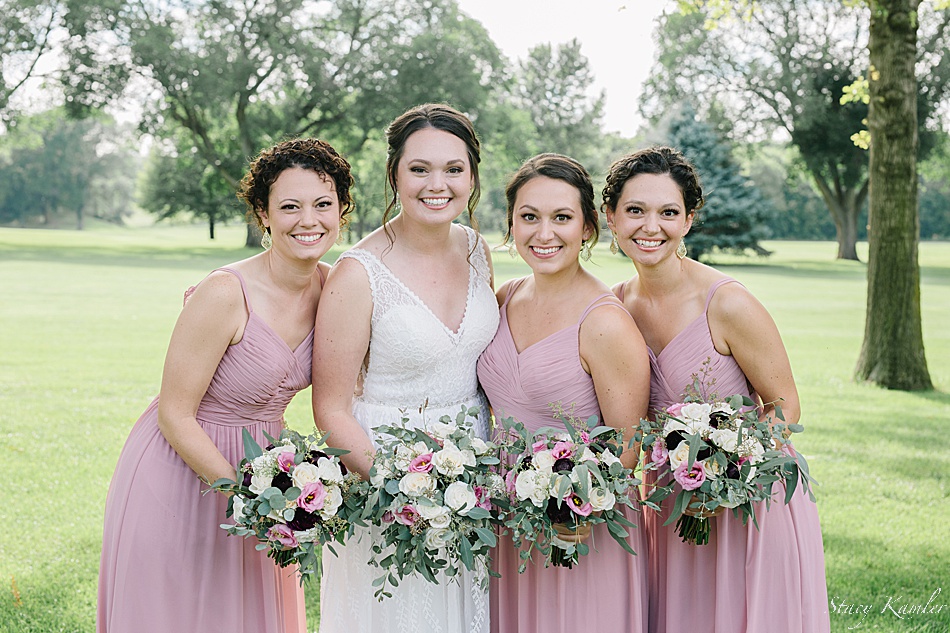 Bridesmaids in dusty pink dresses at the York Country Club