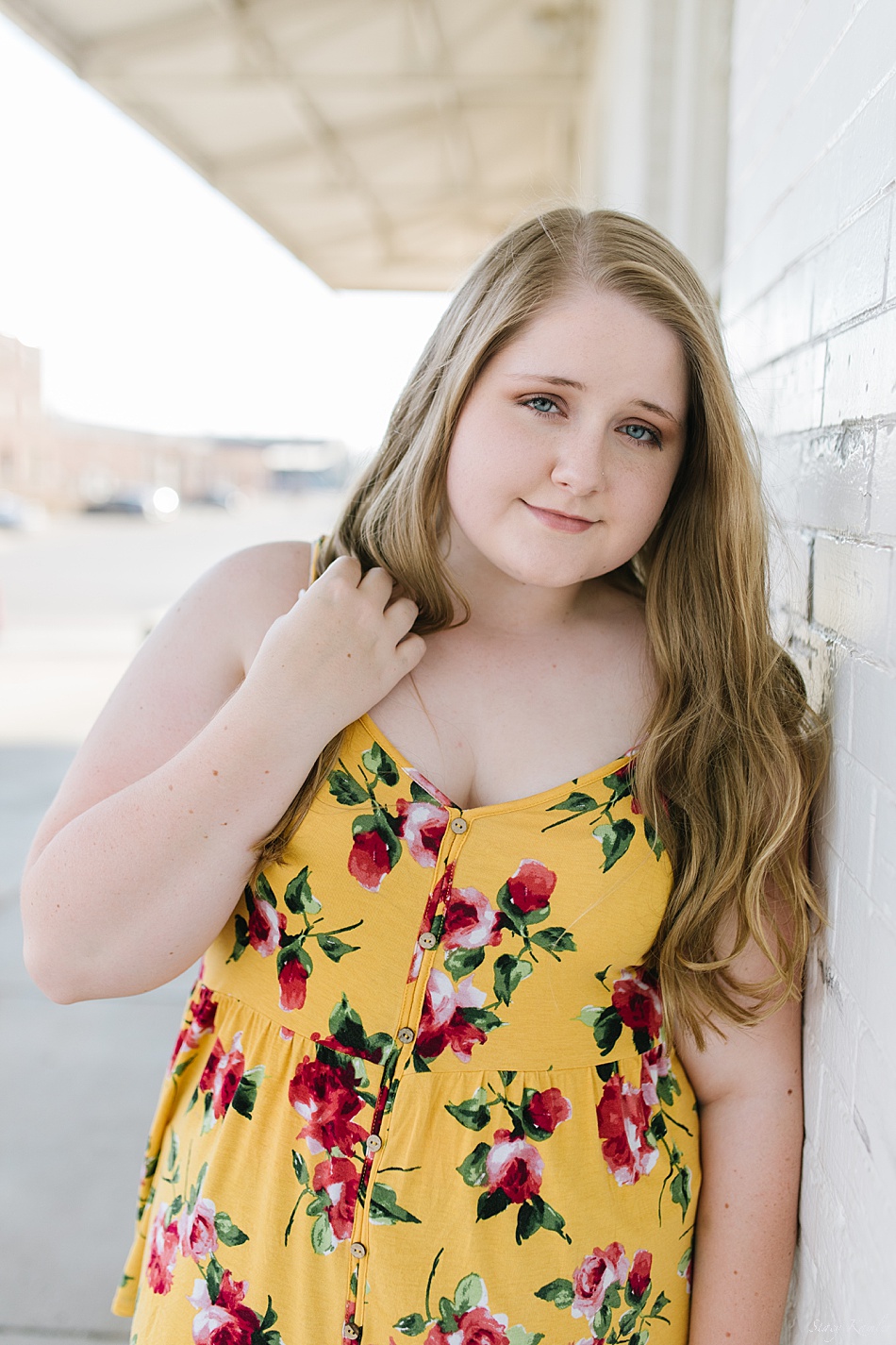 Beautiful senior with blonde hair and yellow tank